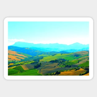 Scenery in Carassai with rolling fields and hazy mountains in the background Sticker